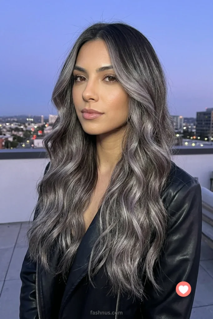 Long, cascading waves featuring a bold silver ash brown color blend, with deep brown roots and cool smoky metallic ends.